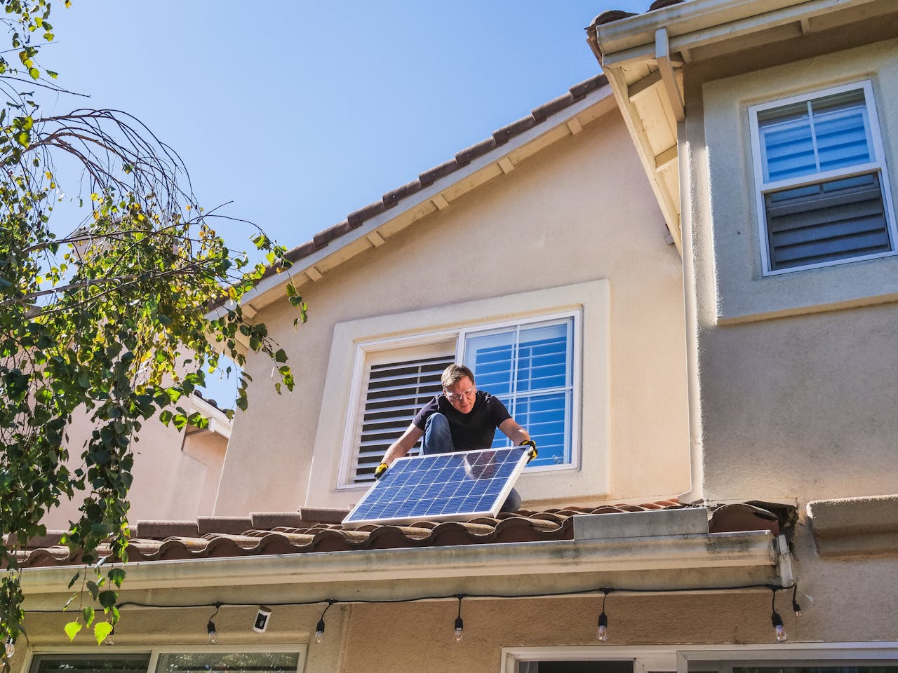 The Art of Drawing Readers In: Your attractive post title goes here Solar technician installing photovoltaic panels on a sunny rooftop.